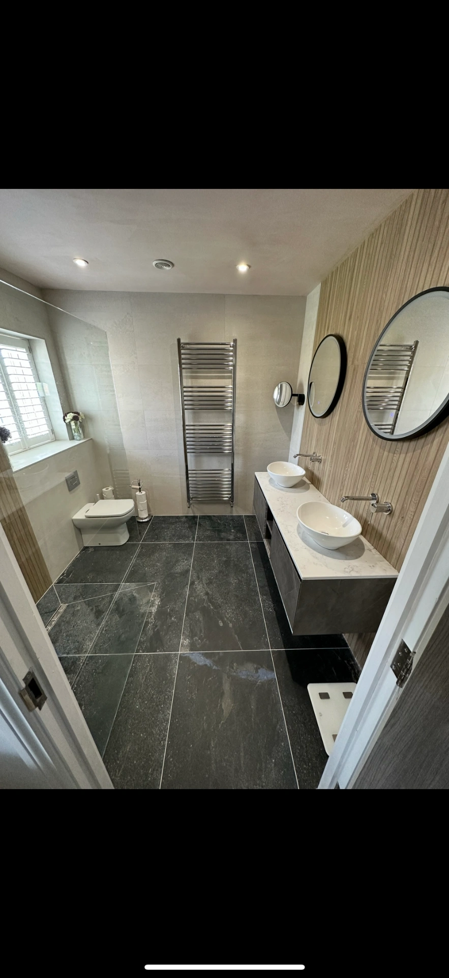 Spacious ensuite with slate floor, oak feature wall and twin vessel basins — Haslemere