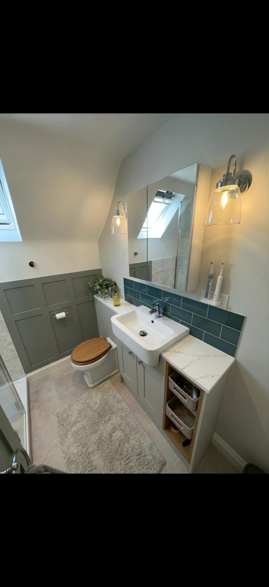 Loft cloakroom with sage panelling, teal tiles and fitted vanity — Haslemere bathroom installers