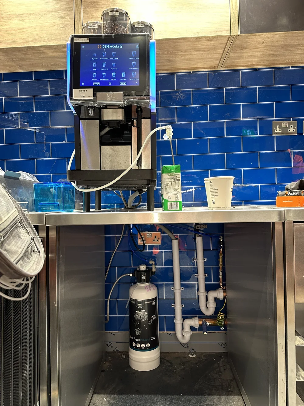 Commercial coffee machine with under-counter water filter and neat plumbing — plumber Haslemere