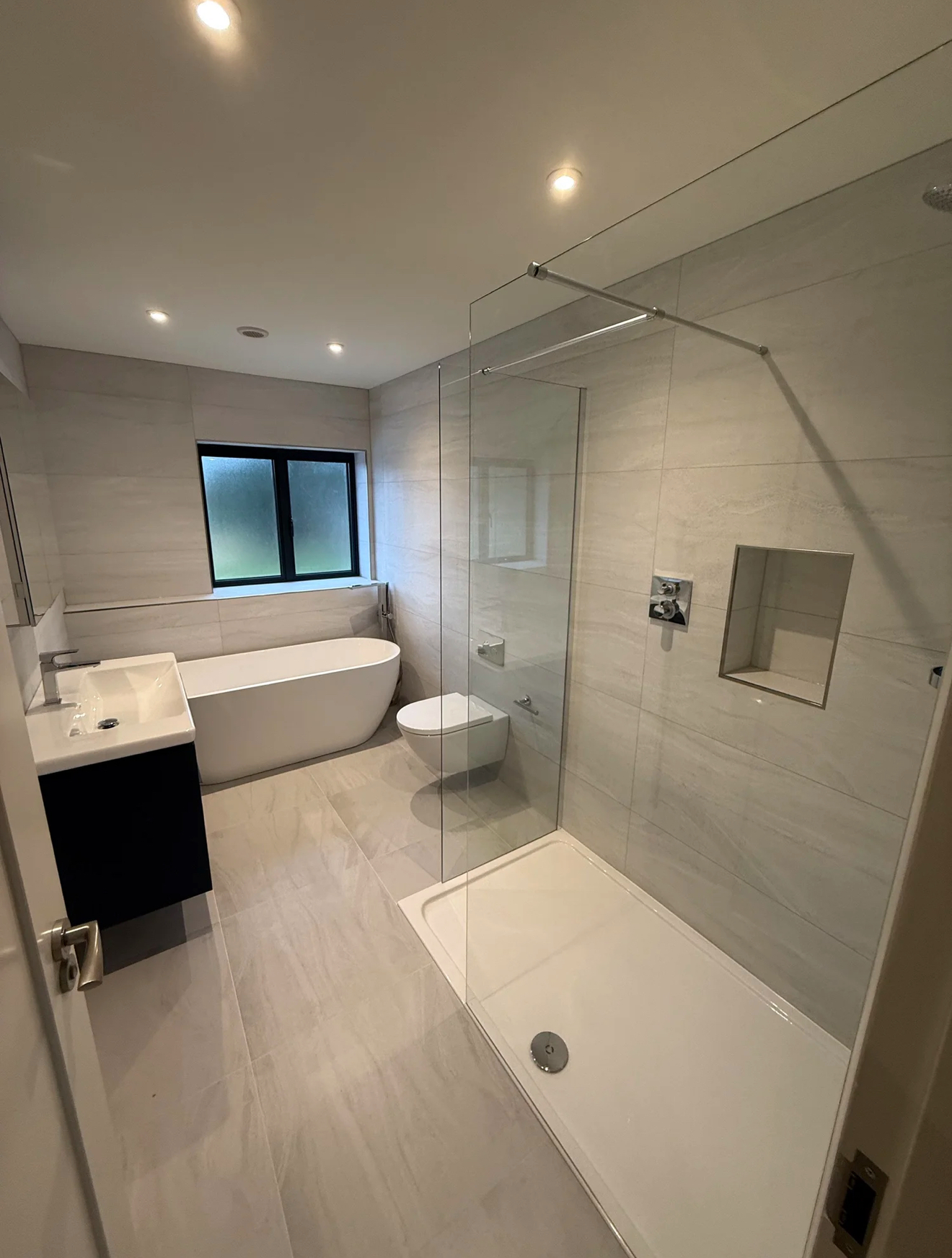 Modern family bathroom with freestanding bath and glass walk-in shower — Haslemere bathroom fitters