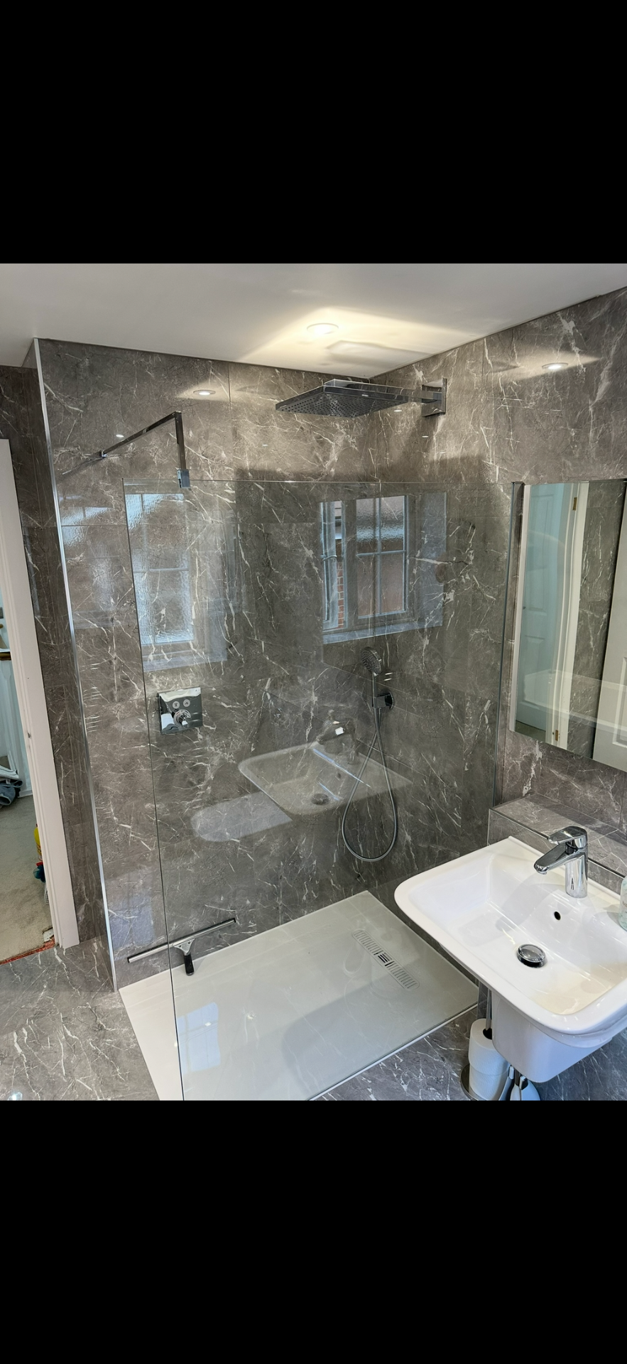 Grey marble walk-in shower with rainfall head and frameless glass — wet room Haslemere