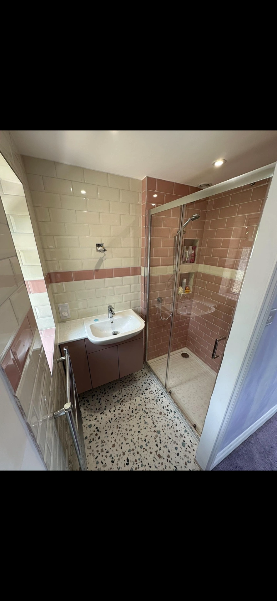 Pink and cream metro-tiled shower room with terrazzo floor — bathroom renovation Haslemere