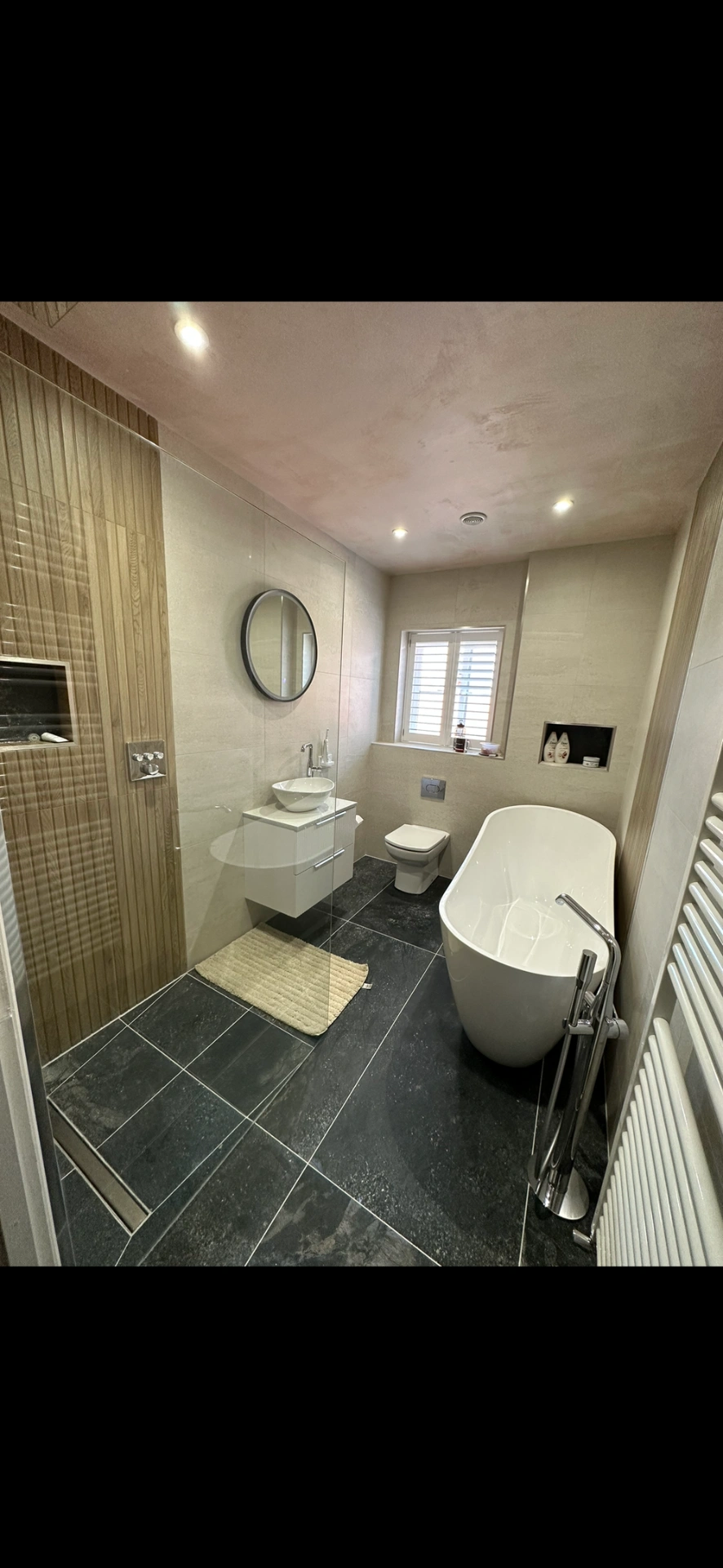 Master bathroom with freestanding tub, slate floor and oak-panelled walk-in shower — bathroom installation Haslemere