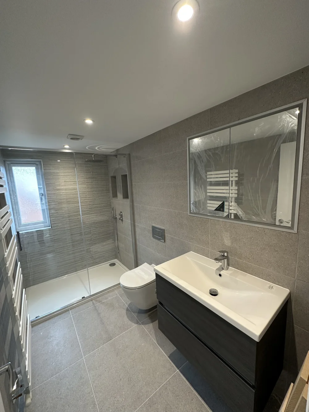Contemporary shower room with graphite vanity, walk-in shower and mirrored cabinet — bathroom renovation Haslemere