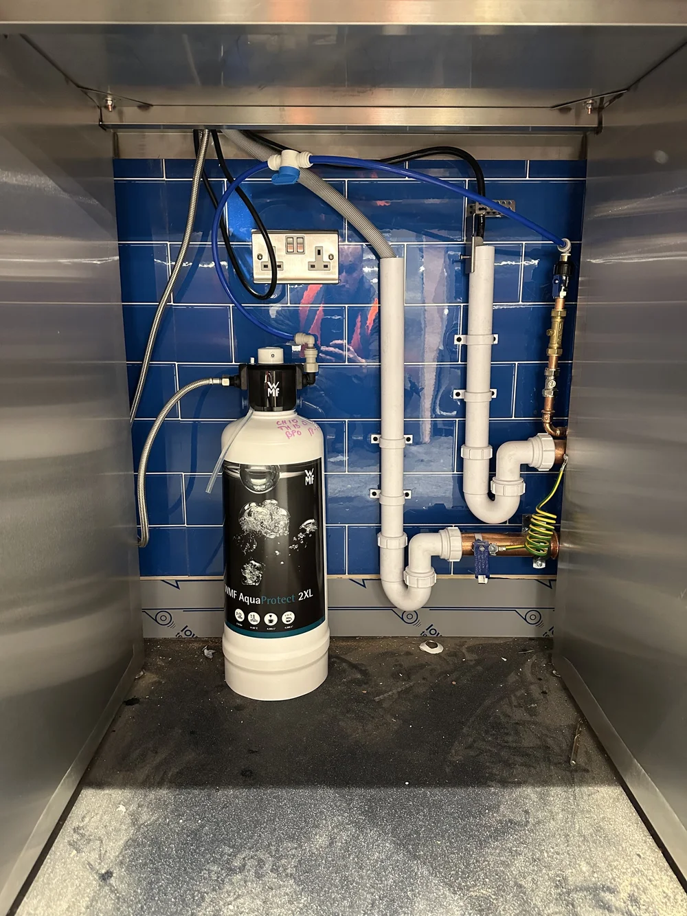 Under-counter WMF AquaProtect water filter and plumbed connections — commercial plumbing Haslemere