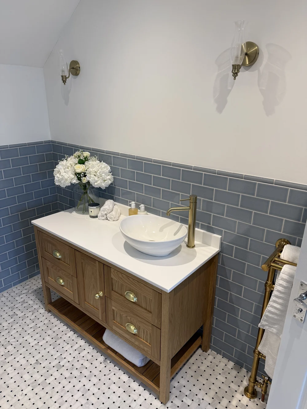 Oak vanity with vessel basin, brass tap and blue metro tiles — bathroom design Haslemere