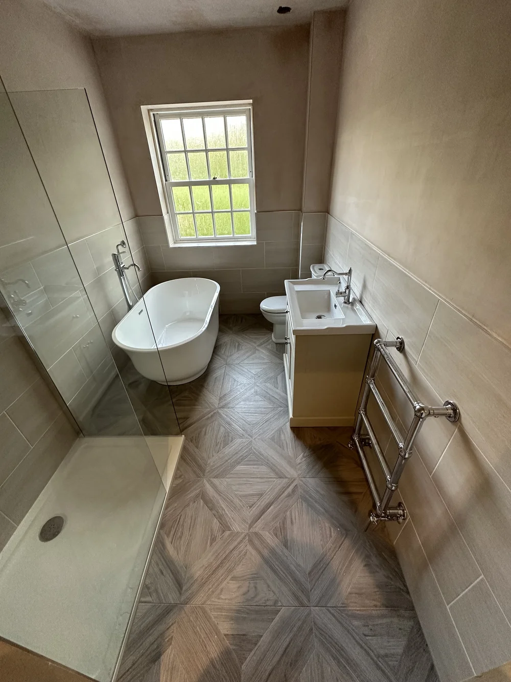 Traditional bathroom with freestanding slipper bath, cream shaker vanity and parquet floor — bathroom renovation Haslemere