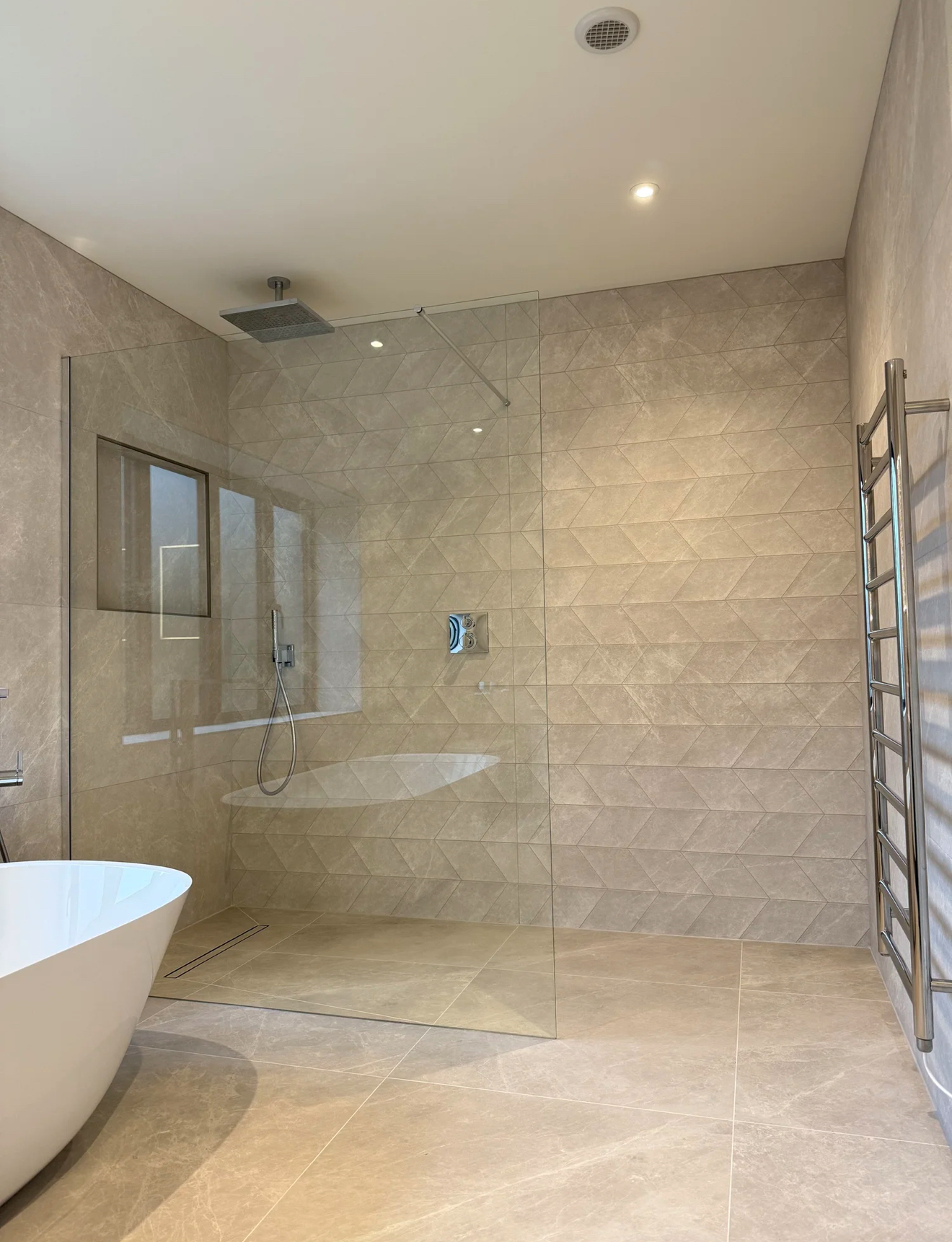 Large tiled wet room with walk-in rainfall shower and freestanding bath — Haslemere bathroom installation